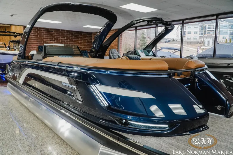 Slide: The Image of 2026 Bennington 25QXFBA pontoon boat displayed at Lake Norman Marina showroom. - 7