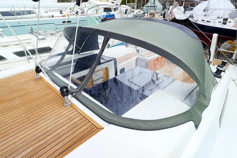 Slide: The Image of 2019 Hanse 418 yacht with a covered cockpit and teak deck. - 11