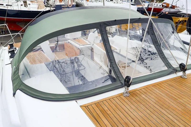 Slide: The Image of 2019 Hanse 418 yacht with green canopy and clear windows at marina. - 12