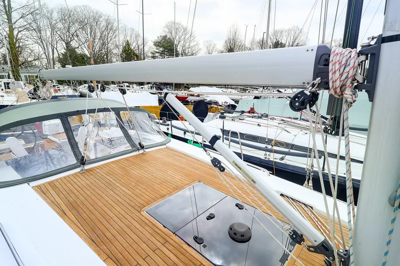 Slide: The Image of 2019 Hanse 418 sailboat deck with teak finish and rigging in marina. - 13