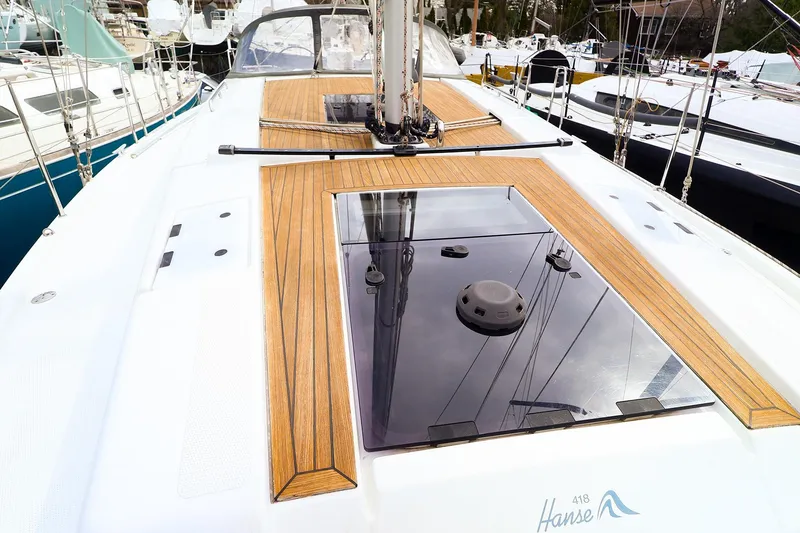 Slide: The Image of 2019 Hanse 418 yacht deck with sleek wood finish and modern design. - 15