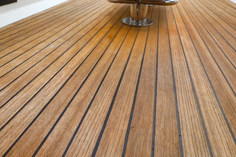 Slide: The Image of Teak deck of 2019 Hanse 418 yacht, showcasing elegant wood grain and craftsmanship. - 19