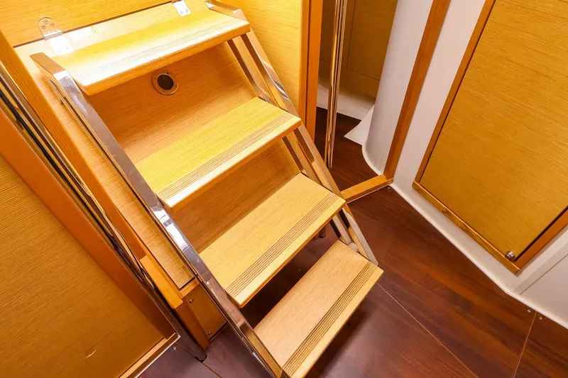 Slide: The Image of Wooden interior stairs on a 2019 Hanse 418 yacht, featuring sleek design and polished finish. - 20