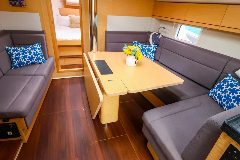Slide: The Image of Interior of 2019 Hanse 418 yacht with cozy seating and decorative pillows. - 21