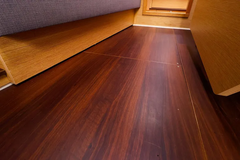 Slide: The Image of Wooden interior flooring of a 2019 Hanse 418 yacht cabin. - 26