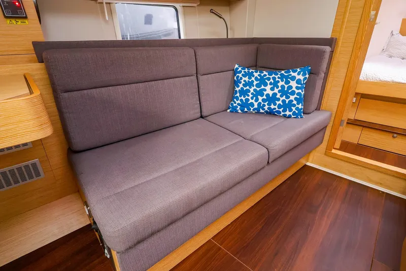 Slide: The Image of Interior of 2019 Hanse 418 yacht with gray sofa and blue patterned pillow. - 27