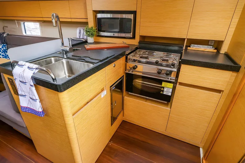 Slide: The Image of Modern kitchen in 2019 Hanse 418 yacht with sink, stove, and microwave. - 31
