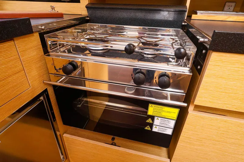 Slide: The Image of Modern kitchen stove in 2019 Hanse 418 yacht, featuring sleek design and wooden cabinetry. - 32