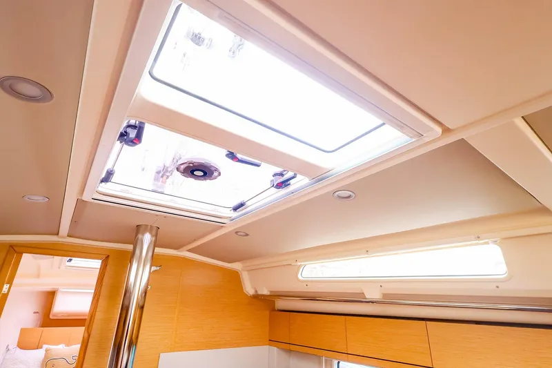Slide: The Image of Interior view of 2019 Hanse 418 yacht, featuring skylight and modern wood finish. - 38