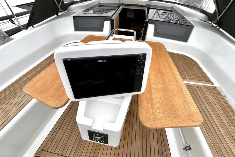 Slide: The Image of Cockpit of 2019 Hanse 418 sailboat with navigation display and wooden seating. - 4