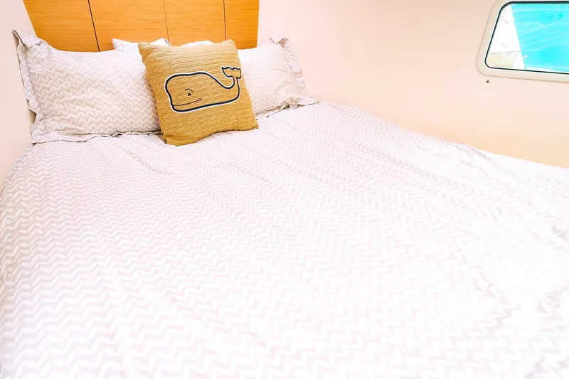 Slide: The Image of Cozy cabin bed in 2019 Hanse 418 yacht with whale-themed pillow and chevron bedding. - 41