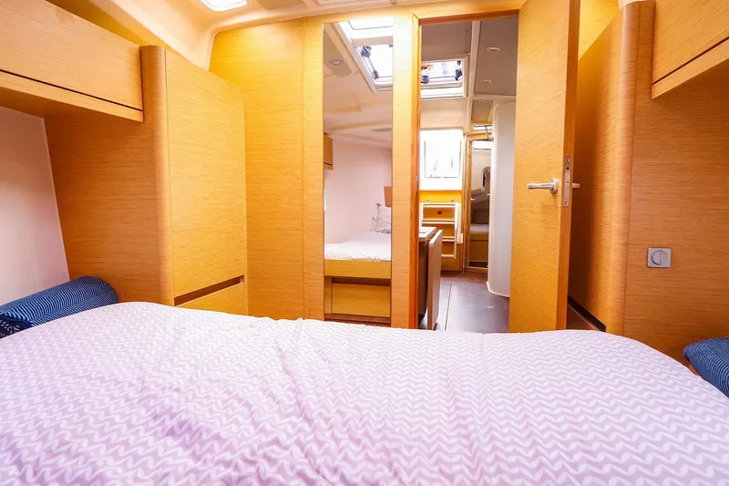Slide: The Image of Interior of 2019 Hanse 418 yacht cabin with wooden finish and cozy bedding. - 43