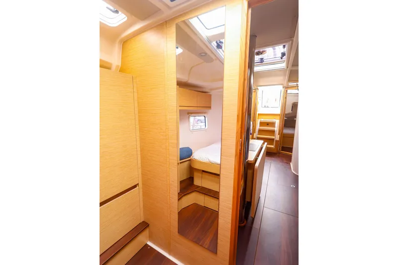 Slide: The Image of Interior of 2019 Hanse 418 yacht, featuring wooden cabinetry and cozy sleeping quarters. - 47