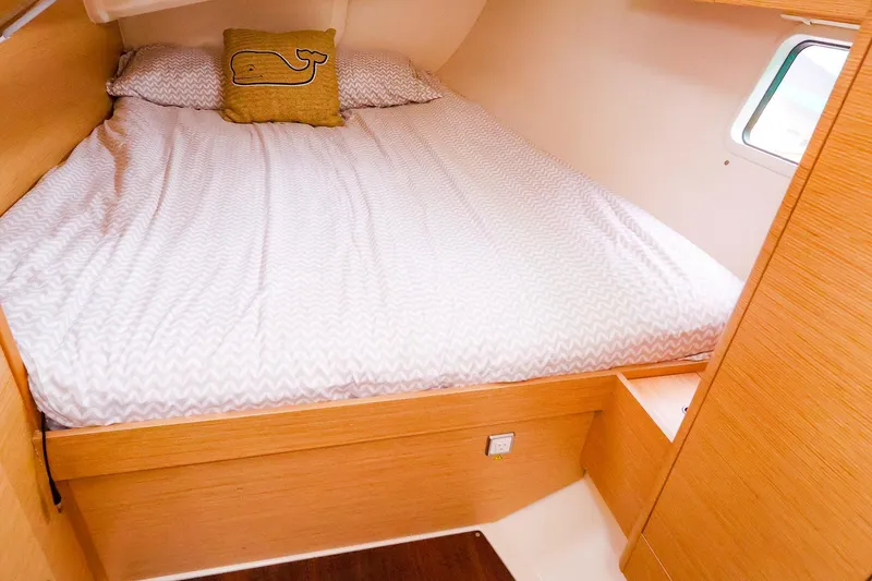 Slide: The Image of Cozy cabin interior of 2019 Hanse 418 yacht with a comfortable bed and whale-themed pillow. - 48