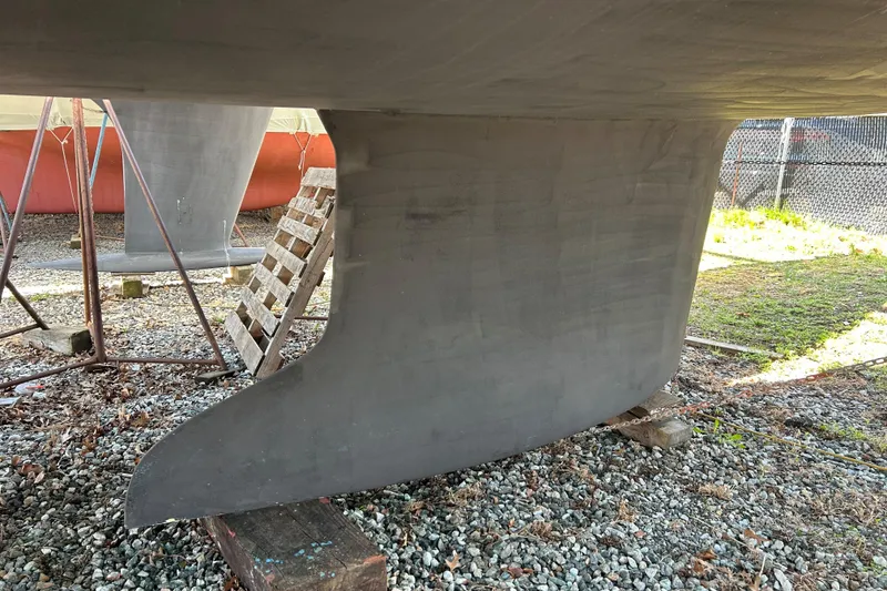 Slide: The Image of 2019 Hanse 418 sailboat keel on dry dock, resting on wooden blocks. - 52