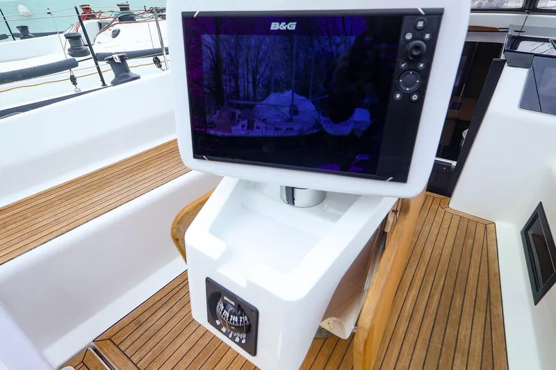 Slide: The Image of Cockpit of 2019 Hanse 418 yacht with navigation display and compass. - 8