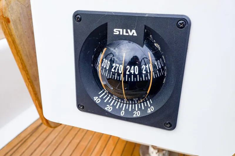 Slide: The Image of Compass on 2019 Hanse 418 yacht, featuring Silva brand, mounted on wooden deck. - 9