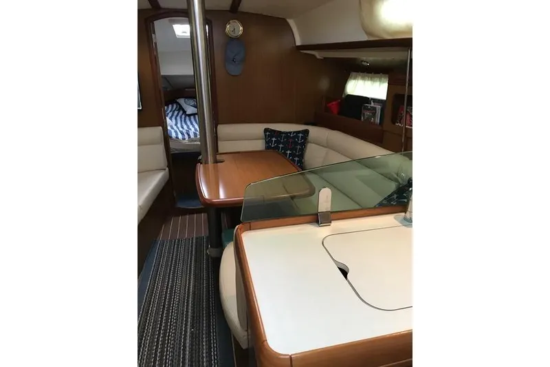 Slide: The Image of Interior of 2007 Jeanneau Sun Odyssey 36i sailboat with cozy seating and dining area. - 17