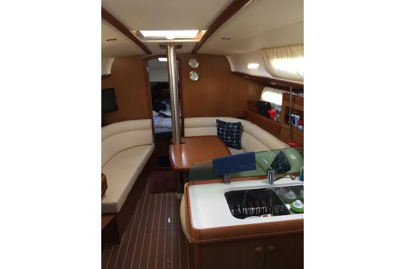 Slide: The Image of Interior of 2007 Jeanneau Sun Odyssey 36i sailboat with cozy seating and kitchenette. - 18