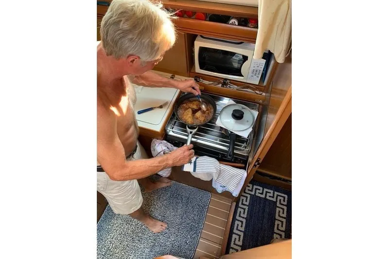 Slide: The Image of Man cooking in Jeanneau Sun Odyssey 36i yacht kitchen, 2007 model. - 20