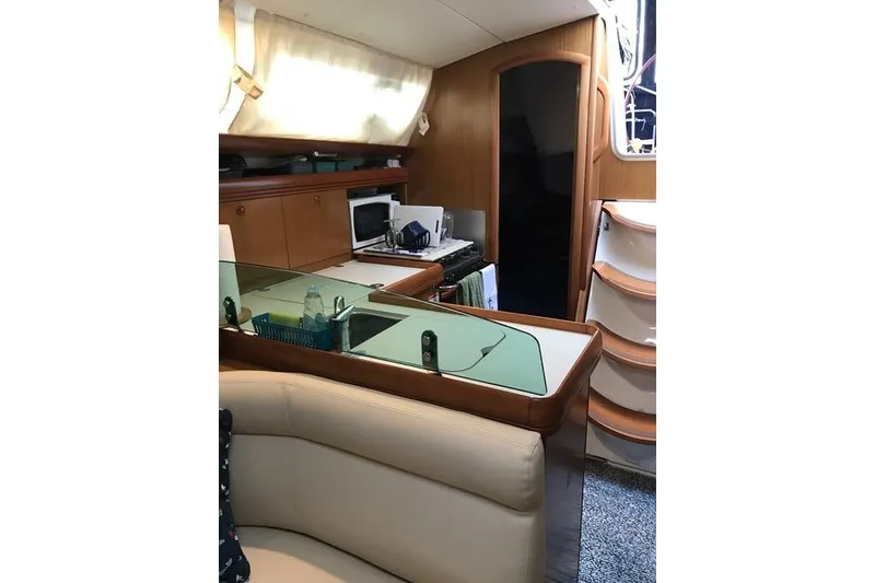 Slide: The Image of Interior of 2007 Jeanneau Sun Odyssey 36i yacht with modern kitchen and seating area. - 21