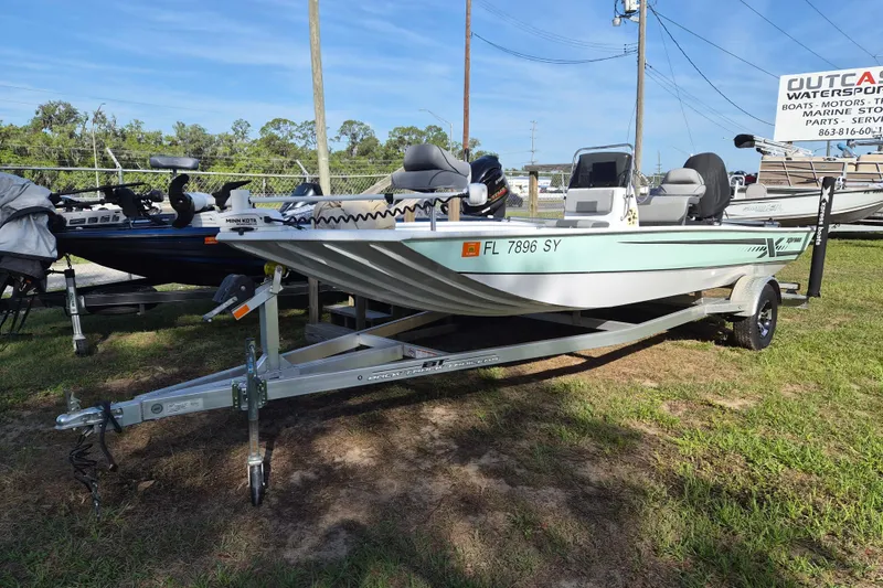The Image of 2021 Xpress XP20CC boat on trailer at dealership, sunny day. - 1