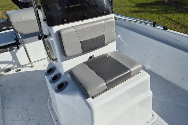 Slide: The Image of 2021 Xpress XP20CC boat interior with gray cushioned seating and rod holders. - 14