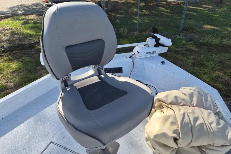 Slide: The Image of 2021 Xpress XP20CC boat seat with Minn Kota trolling motor in outdoor setting. - 17