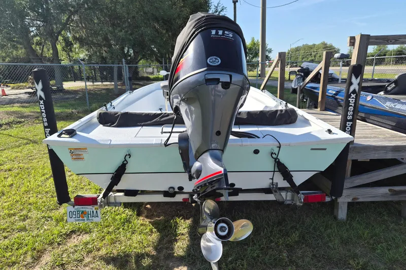 Slide: The Image of 2021 Xpress XP20CC boat with outboard motor on trailer, parked outdoors. - 3