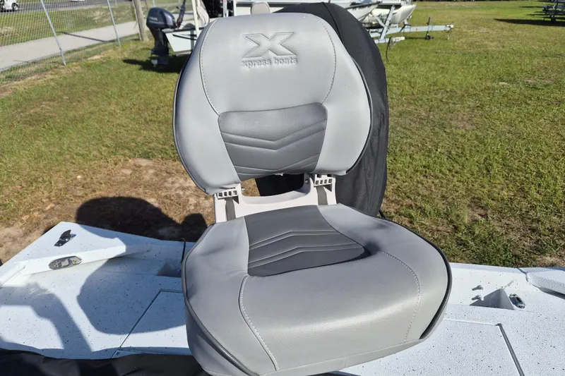 Slide: The Image of Gray seat on a 2021 Xpress XP20CC boat, outdoors on grass. - 8