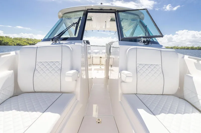 Slide: The Image of Manufacturer Provided Image: 2025 Pursuit DC 306 Dual Console boat interior with white seating and open deck. - 10