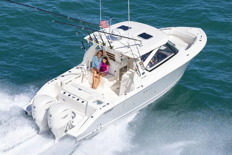 Slide: The Image of Manufacturer Provided Image: 2025 Pursuit DC 306 Dual Console boat cruising on open water. - 3