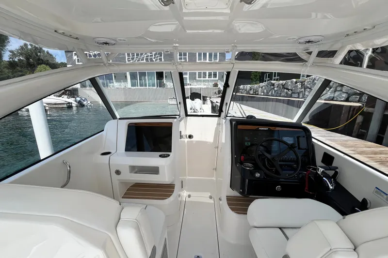 Slide: The Image of 2027 Pursuit DC 326 Dual Console boat interior with modern helm and seating. - 3