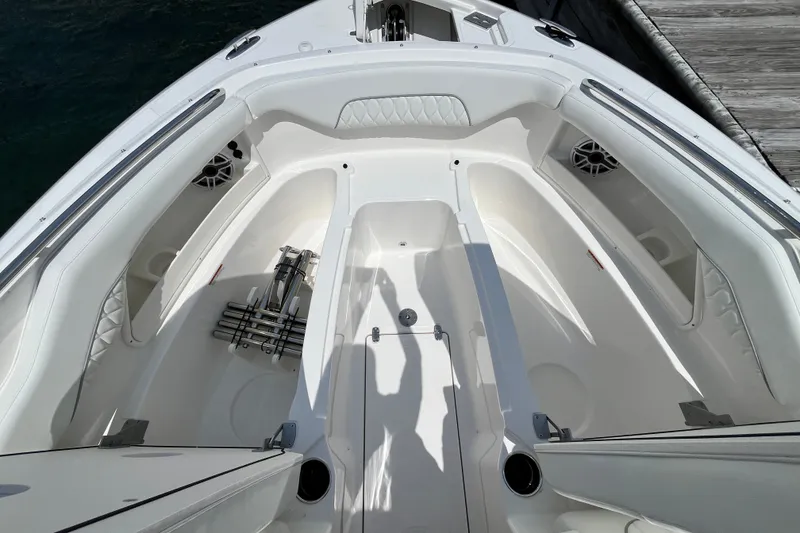 Slide: The Image of 2027 Pursuit DC 326 Dual Console boat interior with seating and storage compartments. - 16