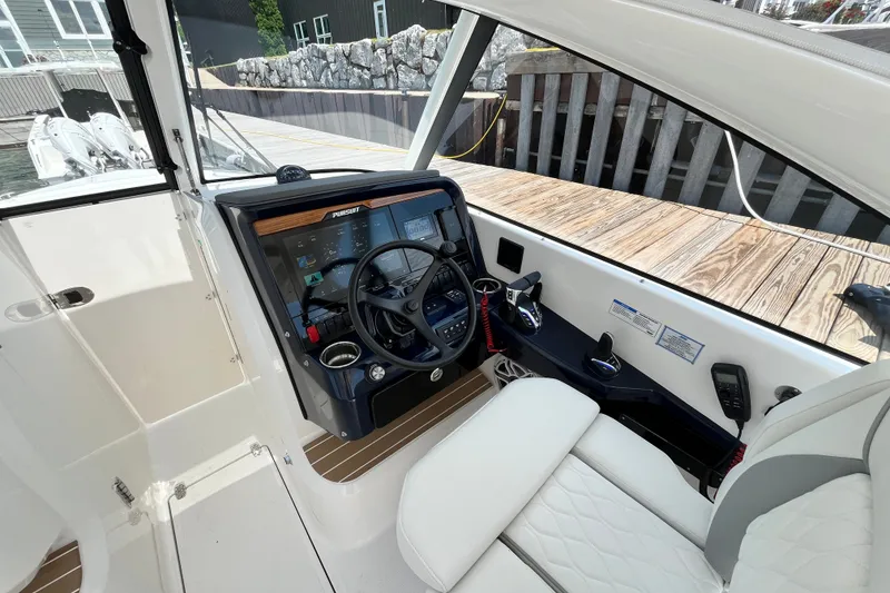 Slide: The Image of 2027 Pursuit DC 326 Dual Console boat interior with modern dashboard and steering wheel. - 1