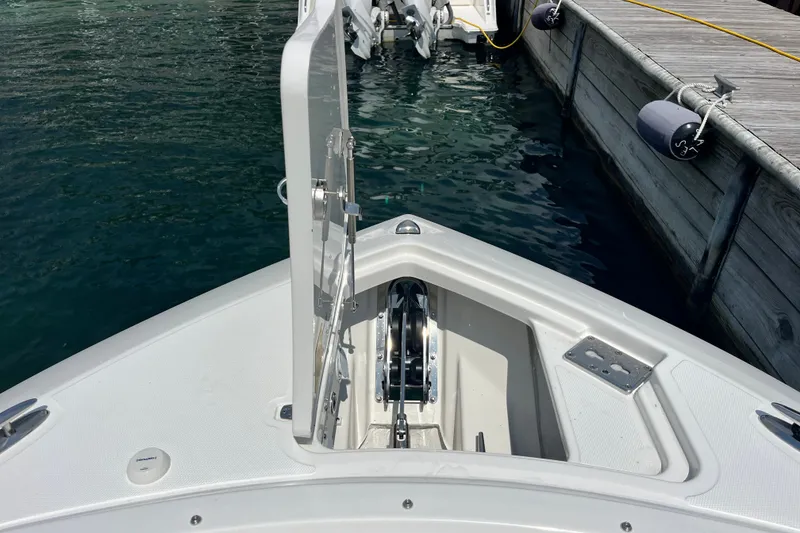 Slide: The Image of Bow view of 2027 Pursuit DC 326 Dual Console at dockside. - 15