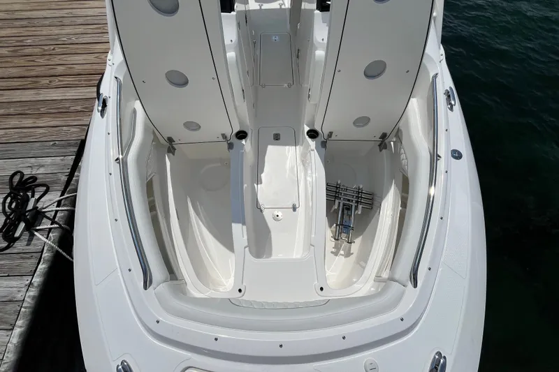 Slide: The Image of 2027 Pursuit DC 326 Dual Console boat interior, featuring spacious seating and storage compartments. - 17