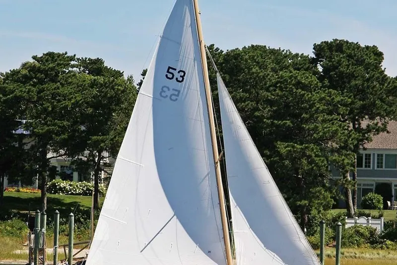 The Image of Sailboat on water, Stuart Marine Knockabout 1997, with white sails and lush greenery background. - 1