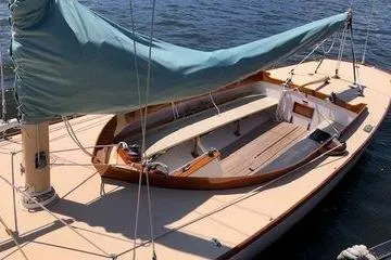 Slide: The Image of 1997 Stuart Marine Knockabout sailboat with covered mast, docked on calm water. - 3