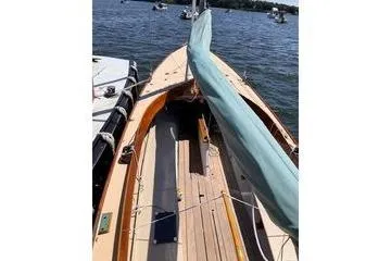 Slide: The Image of 1997 Stuart Marine Knockabout sailboat docked on calm water. - 5