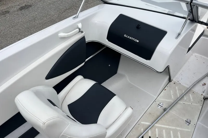 Slide: The Image of 2014 Glastron GT 185 boat interior with white and black seating. - 11