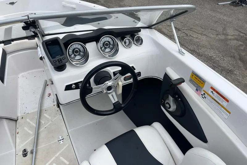 Slide: The Image of 2014 Glastron GT 185 boat dashboard with steering wheel and instrument panel. - 12