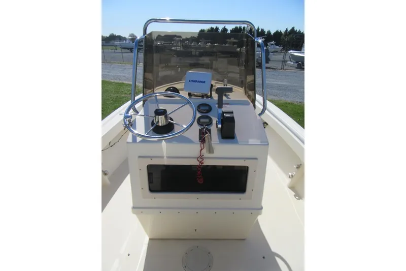 Slide: The Image of 2003 Parker 1801 Center Console boat with steering wheel and navigation equipment. - 13