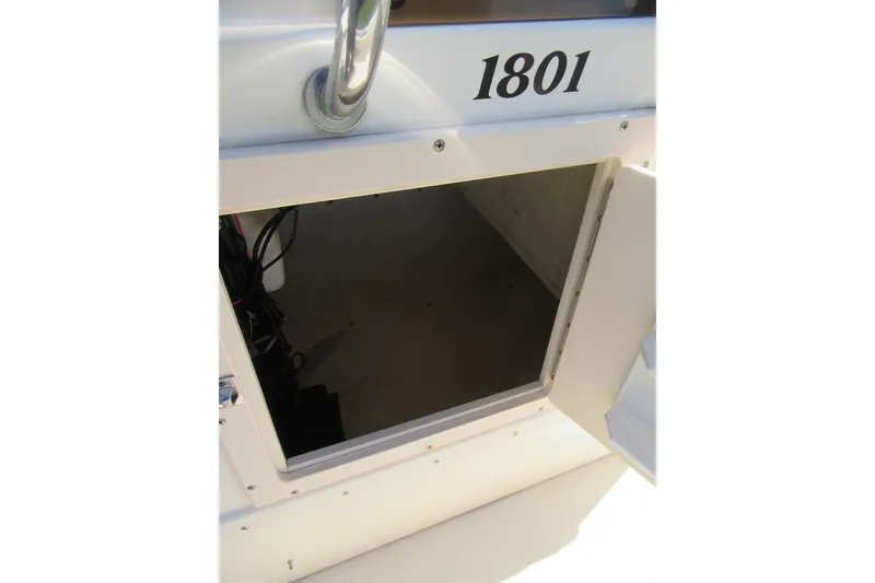 Slide: The Image of Open storage compartment on a 2003 Parker 1801 Center Console boat. - 14