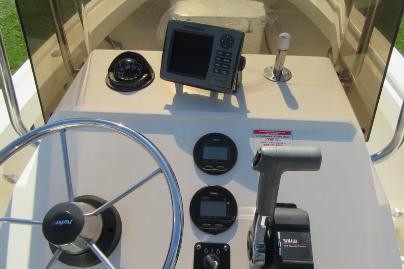 Slide: The Image of Console of a 2003 Parker 1801 Center Console boat with steering wheel and controls. - 15