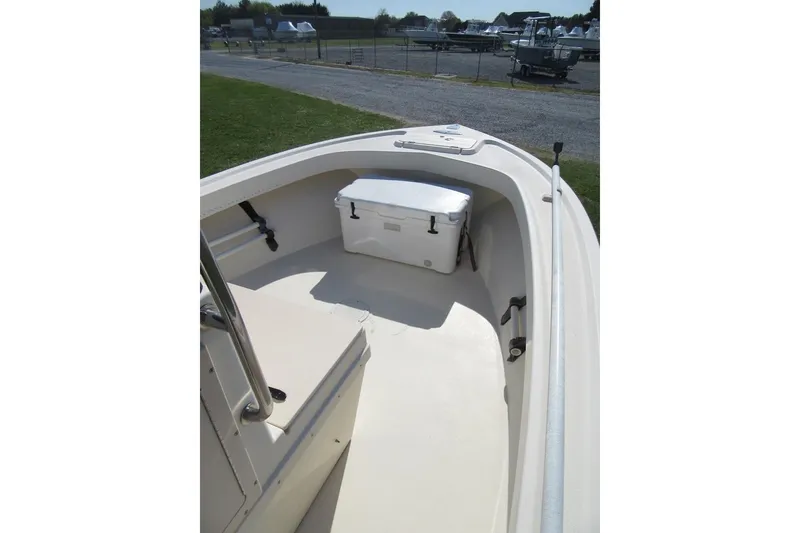 Slide: The Image of 2003 Parker 1801 Center Console boat interior with cooler, docked outdoors. - 16
