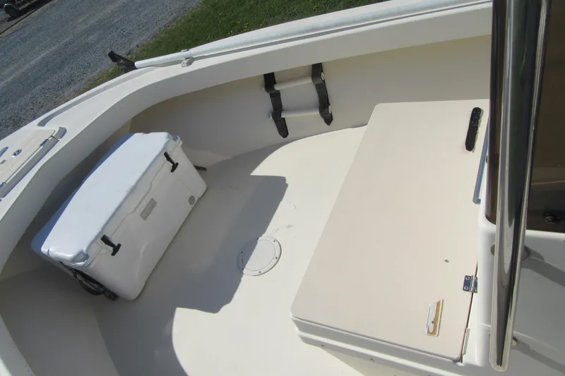 Slide: The Image of 2003 Parker 1801 Center Console boat interior with cooler and seating area. - 18