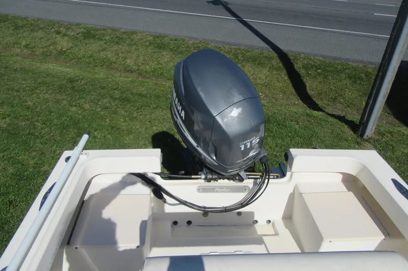 Slide: The Image of 2003 Parker 1801 Center Console boat with Yamaha 115 outboard motor on grassy area. - 4