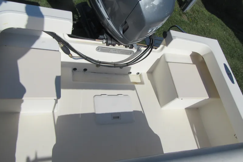 Slide: The Image of 2003 Parker 1801 Center Console boat interior with engine and seating compartments. - 5