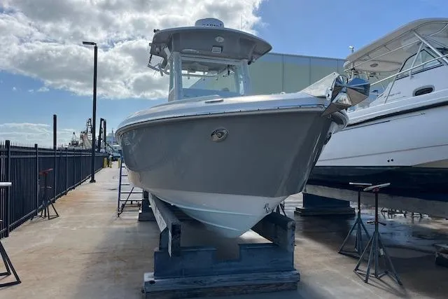 The Image of 2007 Everglades 240 Center Console boat on dry dock under a clear sky. - 1